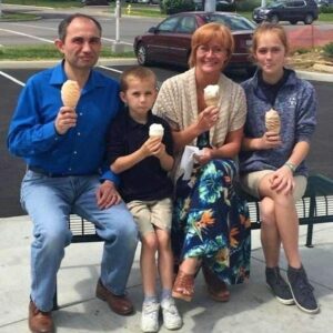 A woman stepped up to take this happy family photo after they had ice cream.